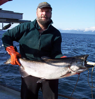 Photo of Mark Stopha holding a salmon