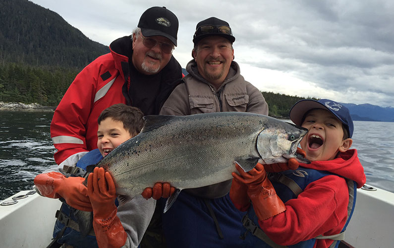 Peterson Family with salmon on a boat