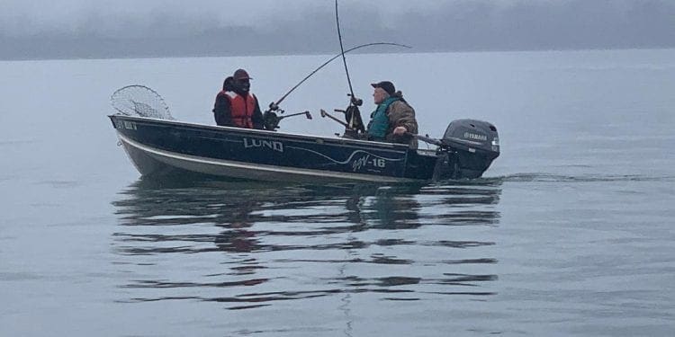 Mark and Andrew fishing on a boat