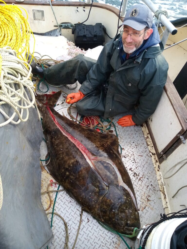 Joe with a large halibut on the boat