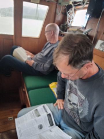 Pat and Sean reading on Mark's boat