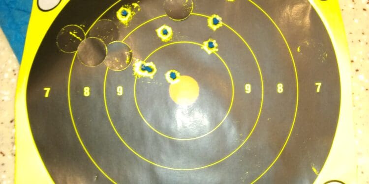 Target shooting score on paper target with hits.