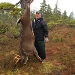 Mark with deer in forest clearing
